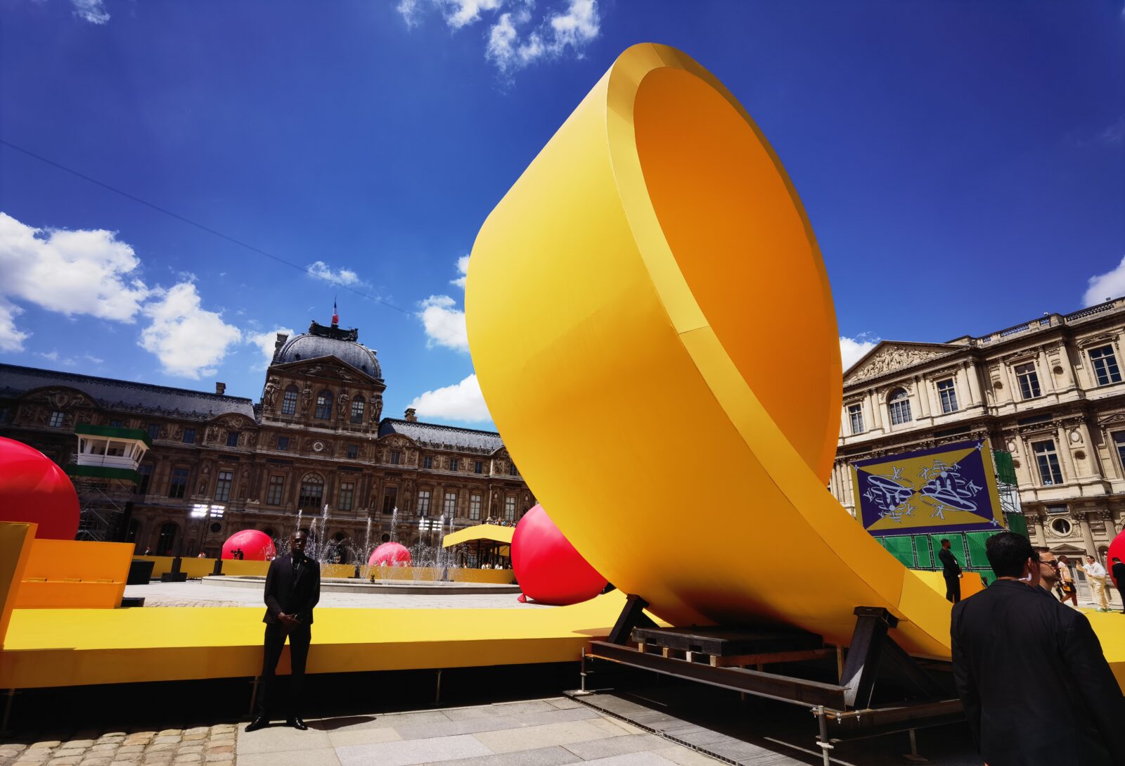 Louis Vuitton inserts a yellow racetrack at the Louvre for Spring Summer  2023 show